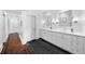 Spacious bathroom with double vanities, marble countertops, and elegant fixtures at 3109 E Warren Ave, Denver, CO 80210