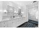 Bright bathroom featuring double sinks, marble countertops, and a glass-enclosed shower at 3109 E Warren Ave, Denver, CO 80210