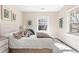 Comfortable bedroom with neutral tones, large windows, and decorative throw pillows at 3109 E Warren Ave, Denver, CO 80210