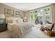 Serene bedroom featuring a neutral color scheme and access to a private outdoor patio with seating at 3109 E Warren Ave, Denver, CO 80210