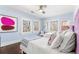 Bright bedroom features two twin beds, three windows, ceiling fan, and hardwood flooring at 3109 E Warren Ave, Denver, CO 80210