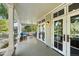 Covered patio with elegant seating and glass doors leading to the home's interior at 3109 E Warren Ave, Denver, CO 80210