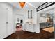 Bright entryway featuring dark hardwood floors, white cabinets and an open flow to the kitchen and living areas at 3109 E Warren Ave, Denver, CO 80210