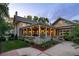 Inviting home with a covered patio, manicured lawn, and beautiful landscaping at 3109 E Warren Ave, Denver, CO 80210