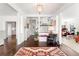 Bright foyer features gleaming hardwood floors, white columns and trim, and views of the staircase and living spaces at 3109 E Warren Ave, Denver, CO 80210