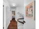 Hallway with hardwood floors, painted walls, and views into a bedroom at 3109 E Warren Ave, Denver, CO 80210