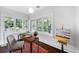 Bright home office with three large windows, wood floors, and a writing desk at 3109 E Warren Ave, Denver, CO 80210