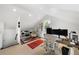 Attic home office space with modern desk setup, skylight, and sloped ceilings at 3109 E Warren Ave, Denver, CO 80210
