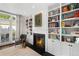 Cozy living room with a fireplace and built-in bookshelves, offering a warm and inviting atmosphere at 3109 E Warren Ave, Denver, CO 80210