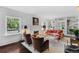 Bright living room featuring hardwood floors, a fireplace, built-in bookshelves, and lots of natural light at 3109 E Warren Ave, Denver, CO 80210