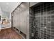 Mud room with custom cabinets, coat hooks, and dark tile shower for pets or cleaning at 3109 E Warren Ave, Denver, CO 80210