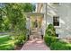Covered front porch features a brick walkway and manicured bushes at 3109 E Warren Ave, Denver, CO 80210
