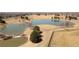 Aerial view of a community pond, walking paths, trees, and open space at 11041 Richfield Cir, Commerce City, CO 80022