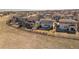 Aerial view of homes showcasing backyard fencing and landscaping in a well-planned community at 11041 Richfield Cir, Commerce City, CO 80022