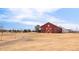 Charming red barn in a scenic community, offering a rustic touch to the neighborhood's landscape at 11041 Richfield Cir, Commerce City, CO 80022