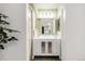 Elegant bathroom vanity with mirrored cabinets, stylish lighting, and neutral tones, creating a serene atmosphere at 11041 Richfield Cir, Commerce City, CO 80022