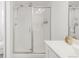 Modern bathroom featuring a glass-enclosed shower and white vanity with solid surface countertop at 11041 Richfield Cir, Commerce City, CO 80022