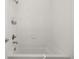 Modern bathtub with white tiling and a shower head at 11041 Richfield Cir, Commerce City, CO 80022