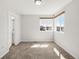 Bright bedroom with neutral walls, plush carpet, and natural light from the windows at 11041 Richfield Cir, Commerce City, CO 80022