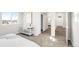 Bedroom showcasing neutral walls, carpeted floor, and view to the bathroom with a sliding door at 11041 Richfield Cir, Commerce City, CO 80022