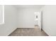 Minimalist bedroom with neutral carpeting, white walls, and an ensuite bathroom at 11041 Richfield Cir, Commerce City, CO 80022