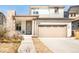 Charming two-story home with a stone accent and a large front-facing two car garage at 11041 Richfield Cir, Commerce City, CO 80022