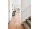 Hallway featuring wood flooring, staircase, and an open view into the kitchen at 11041 Richfield Cir, Commerce City, CO 80022
