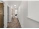 Hallway with neutral walls and carpeted flooring, featuring several doors and recessed lighting at 11041 Richfield Cir, Commerce City, CO 80022