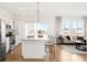 Open-concept kitchen with large island and living area, perfect for entertaining at 11041 Richfield Cir, Commerce City, CO 80022