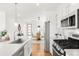 Bright kitchen with dining area in view with modern light fixture and wall decor at 11041 Richfield Cir, Commerce City, CO 80022