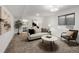 Cozy living room with neutral walls, carpet, stylish furniture, and open view to the bathroom at 11041 Richfield Cir, Commerce City, CO 80022