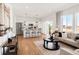 Open-concept living room and kitchen area with hardwood floors and modern design at 11041 Richfield Cir, Commerce City, CO 80022