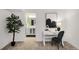 Bright office space with modern desk, stylish chair, and plant, complemented by an adjoining bathroom view at 11041 Richfield Cir, Commerce City, CO 80022