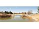 Scenic community pond offering a tranquil view with mature trees and calm waters, enhancing the landscape at 11041 Richfield Cir, Commerce City, CO 80022