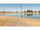 Picturesque community pond with a walking path, street light, and mountain views at 11041 Richfield Cir, Commerce City, CO 80022