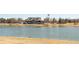 Scenic view of a clubhouse overlooking a pond with an American flag flying overhead at 11041 Richfield Cir, Commerce City, CO 80022