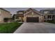 Two-story house with brown siding, gray driveway, and landscaped lawn at 10600 W Weaver Dr, Littleton, CO 80127