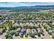 Wide aerial view of neighborhood with mountain backdrop at 10600 W Weaver Dr, Littleton, CO 80127