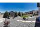 Backyard with rock landscaping, lawn, mature trees, and view of the mountains at 4465 Mesa Top Dr, Monument, CO 80132