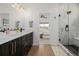This bathroom showcases a double vanity, glass-enclosed shower, and modern fixtures at 4465 Mesa Top Dr, Monument, CO 80132