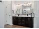 Bathroom features a double vanity, modern lighting, and a glass-enclosed shower at 4465 Mesa Top Dr, Monument, CO 80132