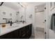 Bathroom features double sinks, dark wood cabinets, and white subway tiles in shower at 4465 Mesa Top Dr, Monument, CO 80132