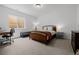 Comfortable bedroom with wood bed frame, desk, and natural light at 4465 Mesa Top Dr, Monument, CO 80132