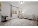 Bright Bedroom featuring a crib, armchair, and area rug with soft, neutral tones at 4465 Mesa Top Dr, Monument, CO 80132