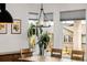 Bright dining area with modern chandelier and multiple windows overlooking the lush backyard at 4465 Mesa Top Dr, Monument, CO 80132