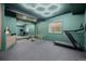 Home gym featuring a treadmill, weight bench, mirrored wall, and ample workout space at 4465 Mesa Top Dr, Monument, CO 80132