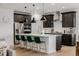 Modern kitchen features a large island with seating, stainless steel appliances, and dark cabinets at 4465 Mesa Top Dr, Monument, CO 80132