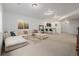 An airy living room with large couch, gold coffee table, bar, and lots of space to relax at 4465 Mesa Top Dr, Monument, CO 80132