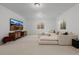 Expansive living room with a sectional couch, media center, and natural light from the window at 4465 Mesa Top Dr, Monument, CO 80132