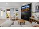 Elegant living room with a modern fireplace, sliding glass door, and comfortable furniture at 4465 Mesa Top Dr, Monument, CO 80132
